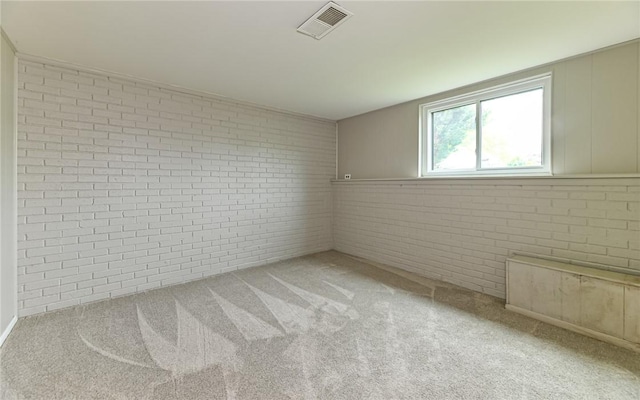 219 Parkwood Dr, Cranberry Twp, PA 16066 - carpeted empty room with brick wall and visible vents