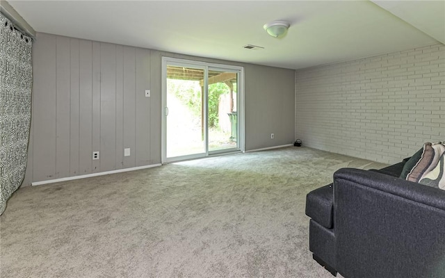 219 Parkwood Dr, Cranberry Twp, PA 16066 - unfurnished living room with brick wall, baseboards, visible vents, and carpet