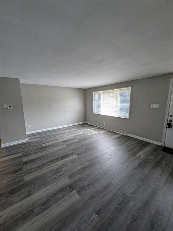 300 Thompson Ave, Clairton, PA 15025 - spare room with baseboards and dark wood-type flooring