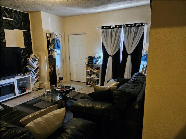 living area with wood finished floors and a textured ceiling