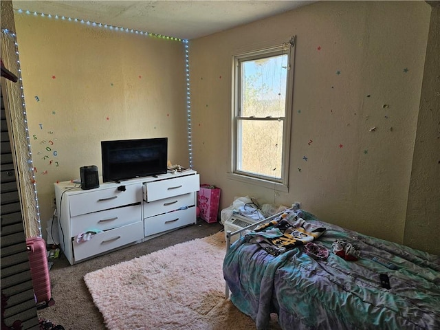 carpeted bedroom featuring multiple windows