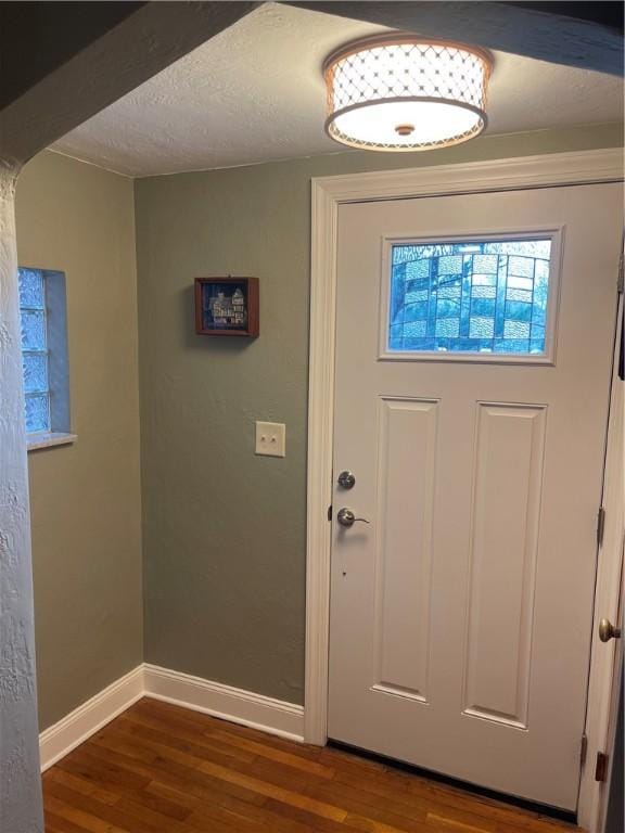 entryway featuring wood finished floors and baseboards