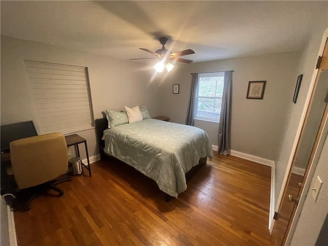 bedroom with baseboards, a ceiling fan, and wood finished floors