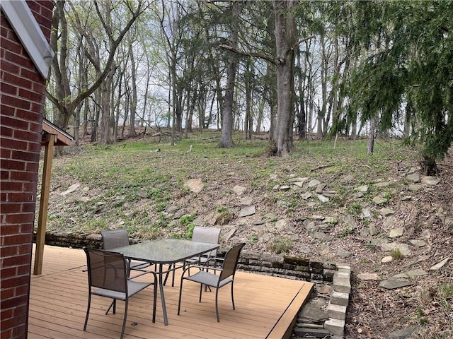 wooden deck featuring outdoor dining space