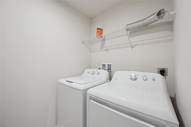 clothes washing area featuring washing machine and dryer and laundry area