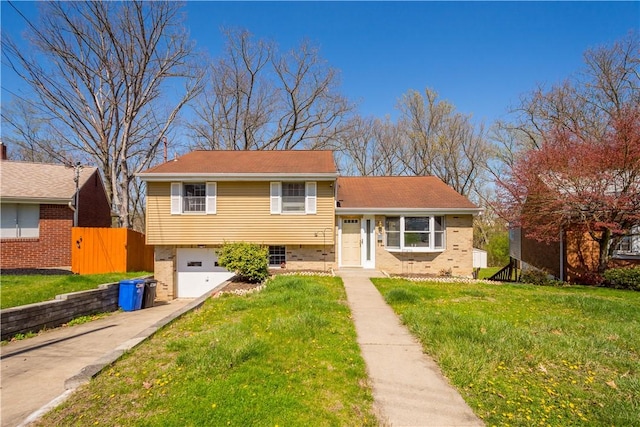 169 Balver Ave, Banksville/Westwood, PA 15205 - tri-level home with concrete driveway, brick siding, fence, and a garage