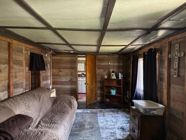carpeted bedroom with wood walls