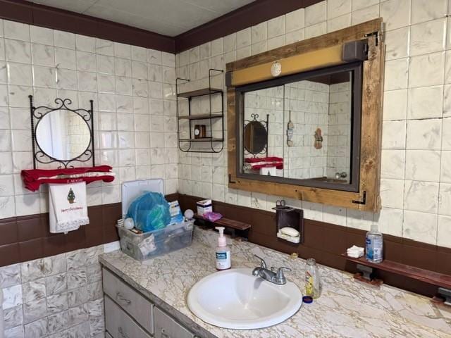 bathroom with vanity and tile walls