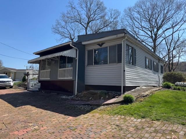 view of front of property featuring a sunroom