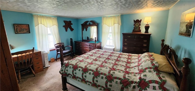 bedroom with carpet flooring, multiple windows, and a textured ceiling