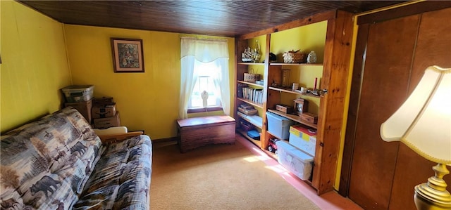 sitting room with wood ceiling and carpet flooring