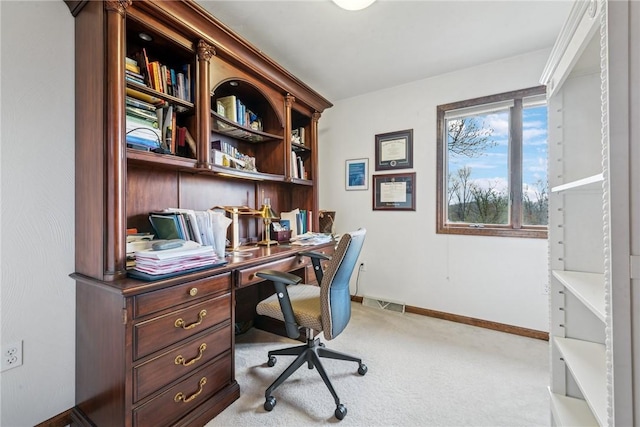office with built in desk, carpet, visible vents, and baseboards