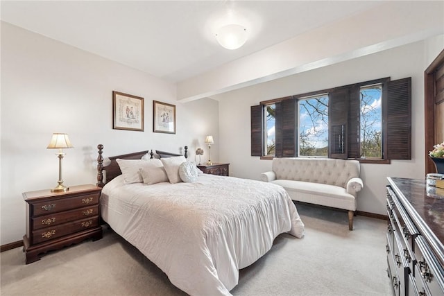 bedroom featuring baseboards and light colored carpet