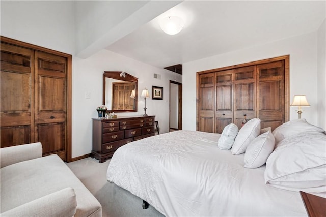 bedroom with light colored carpet and visible vents