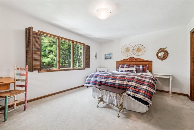 carpeted bedroom featuring baseboards