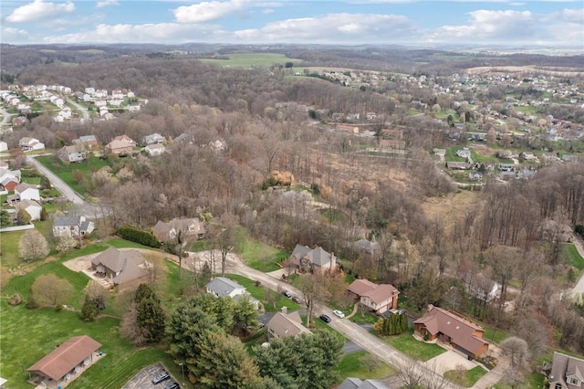 drone / aerial view featuring a residential view and a forest view
