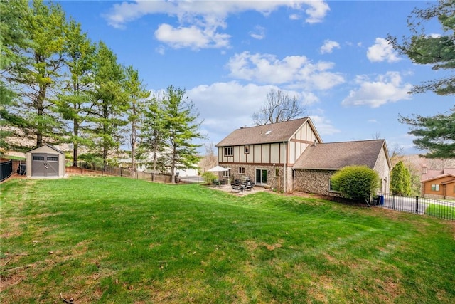 view of yard featuring a patio, an outbuilding, a shed, and a fenced backyard