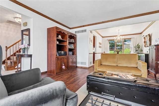 living area with stairway, wood finished floors, visible vents, ornamental molding, and a chandelier