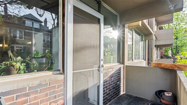 doorway to property with brick siding