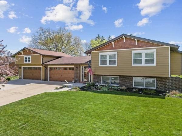 1420 Fernledge Dr, Shaler, PA 15101 - split level home featuring brick siding, a garage, driveway, and a front lawn