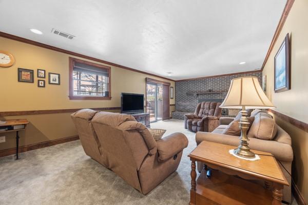 1420 Fernledge Dr, Shaler, PA 15101 - living area featuring visible vents, baseboards, crown molding, and light colored carpet