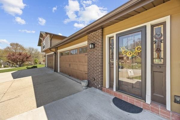 1420 Fernledge Dr, Shaler, PA 15101 - doorway to property with brick siding, an attached garage, and concrete driveway