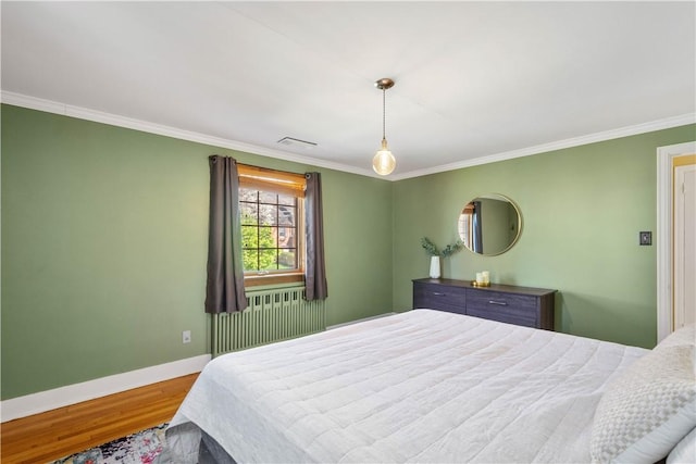159 Inglewood Dr, Mt Lebanon, PA 15228 - bedroom featuring wood finished floors, radiator, baseboards, ornamental molding, and visible vents