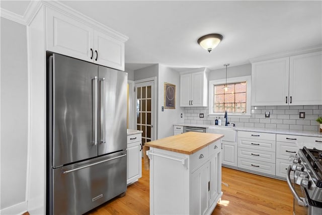 159 Inglewood Dr, Mt Lebanon, PA 15228 - kitchen with decorative backsplash, appliances with stainless steel finishes, butcher block counters, and light wood-style flooring