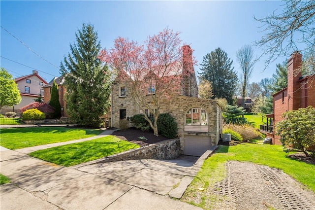 159 Inglewood Dr, Mt Lebanon, PA 15228 - view of front of house featuring an attached garage, driveway, stone siding, and a front lawn