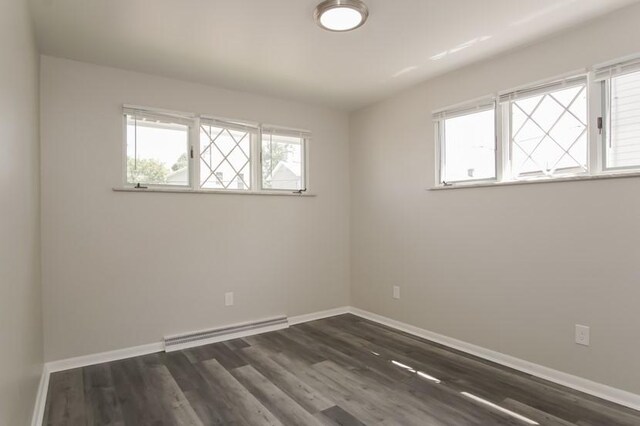 600 Indiana Ave, Monaca, PA 15061 - empty room featuring a baseboard heating unit, baseboards, and dark wood-style floors