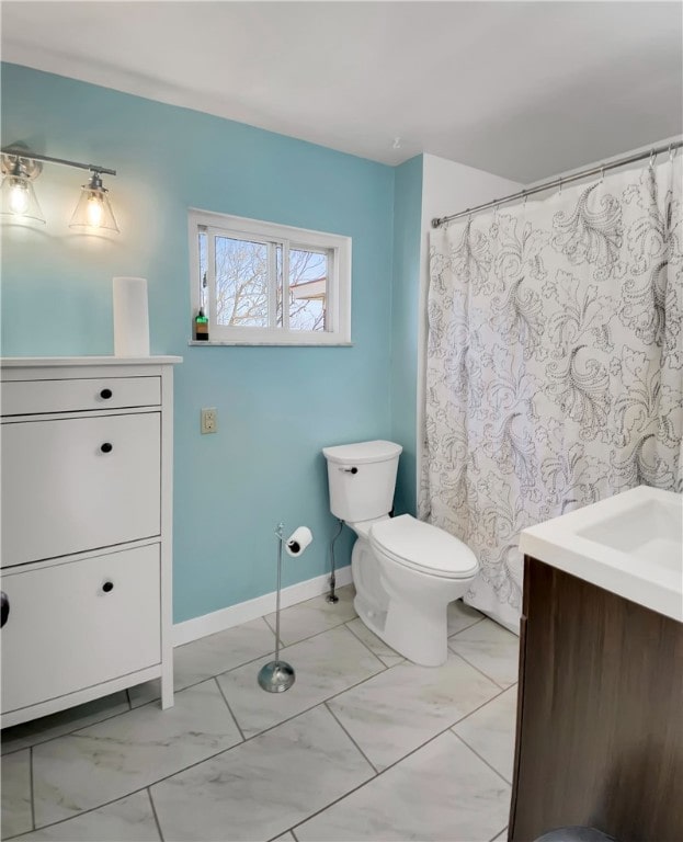 bathroom featuring baseboards, vanity, marble finish floor, and toilet