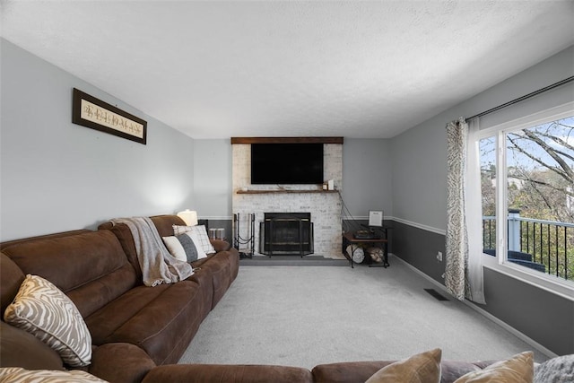 carpeted living room featuring a fireplace, plenty of natural light, and baseboards