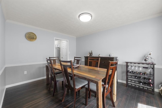 dining area featuring hardwood / wood-style flooring, baseboards, and ornamental molding