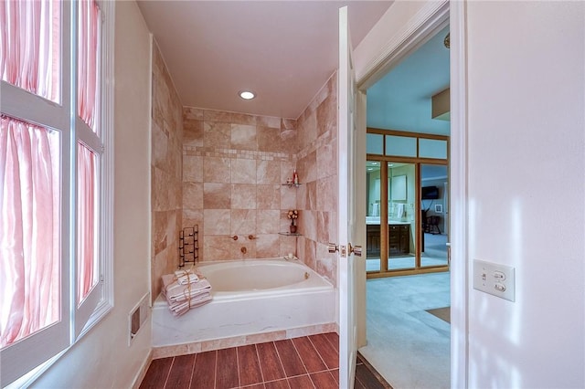 bathroom featuring wood finished floors, recessed lighting, and baseboards