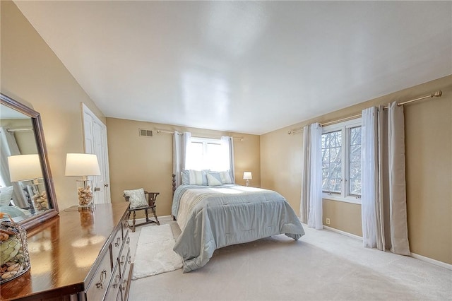 bedroom featuring baseboards and light carpet