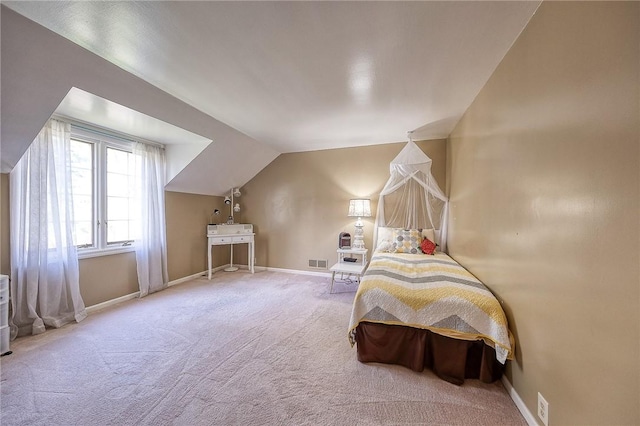bedroom with carpet flooring, lofted ceiling, and baseboards