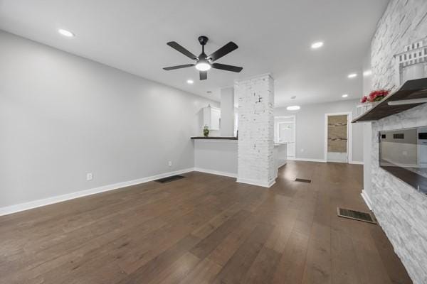 unfurnished living room with recessed lighting, ceiling fan, baseboards, visible vents, and dark wood-type flooring