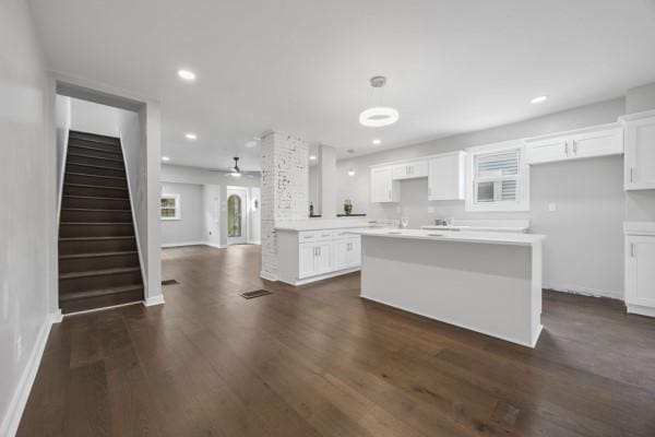 kitchen featuring a center island, white cabinetry, and dark wood finished floors