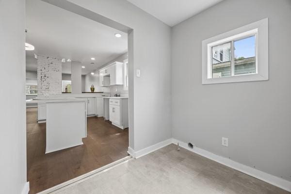 interior space featuring light countertops, recessed lighting, white cabinets, and baseboards