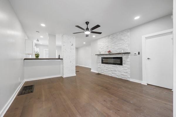 unfurnished living room featuring recessed lighting, wood finished floors, ceiling fan, a fireplace, and visible vents