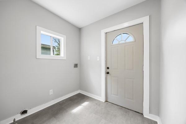 entryway with concrete floors and baseboards