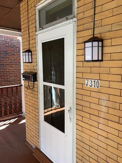7310 Church St, Swissvale, PA 15218 - doorway to property with brick siding