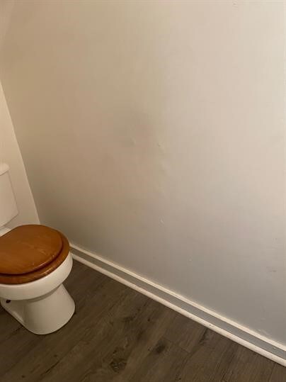 7310 Church St, Swissvale, PA 15218 - bathroom with baseboards, toilet, and wood finished floors