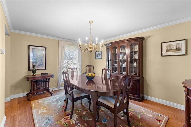 3216 Postgate Dr, Bethel Park, PA 15102 - dining space featuring baseboards, a notable chandelier, crown molding, and light wood finished floors