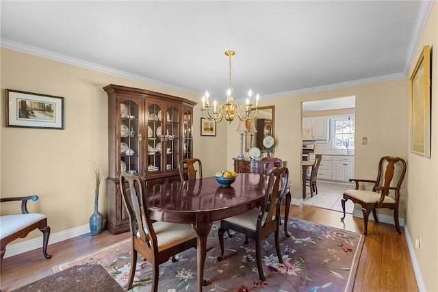 3216 Postgate Dr, Bethel Park, PA 15102 - dining area featuring baseboards, ornamental molding, a chandelier, and light wood-style floors