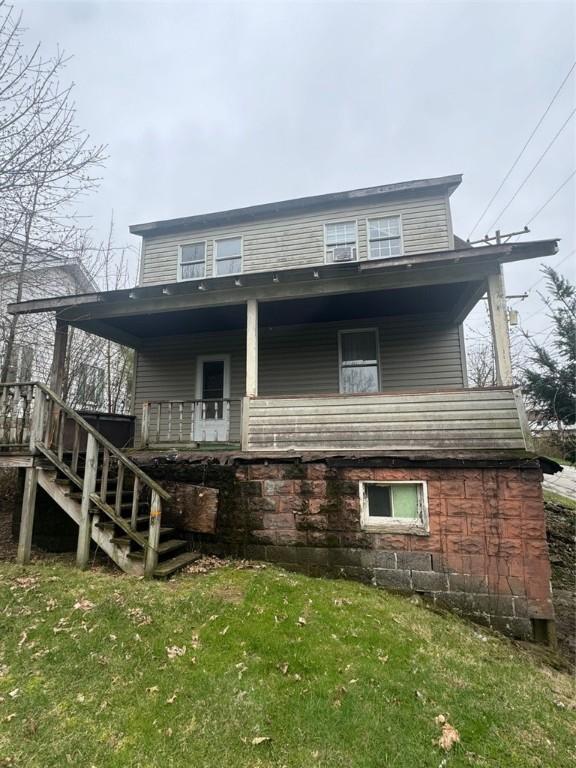 1501 Stewart St, New Kensington, PA 15068 - back of property featuring a yard, stairs, and covered porch