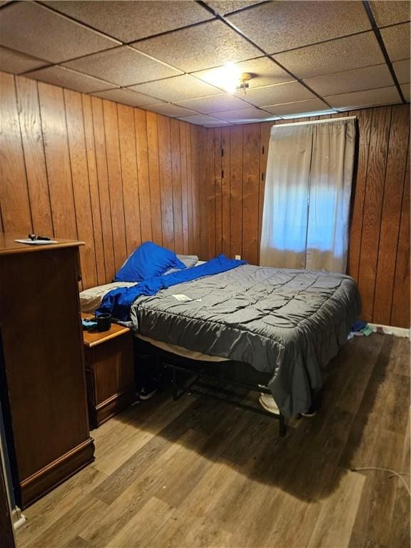 802 10th St, Stowe Twp, PA 15136 - bedroom with wooden walls, a drop ceiling, and light wood finished floors