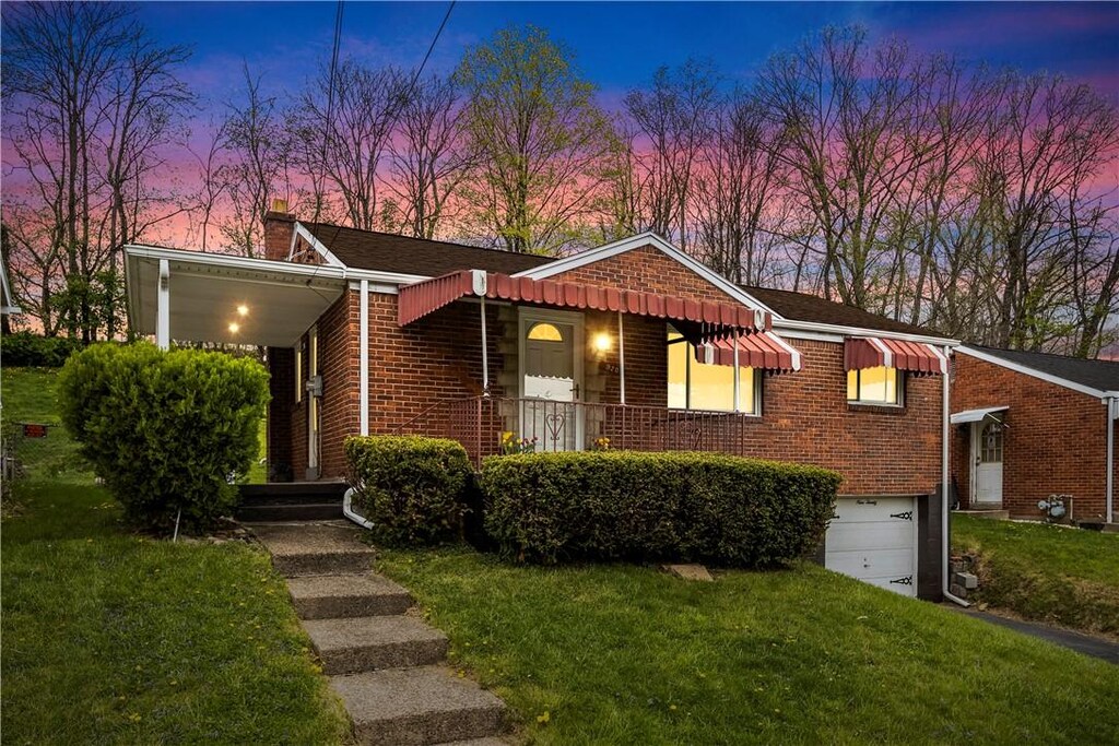 920 Woodland Ave, Port Vue, PA 15133 - ranch-style house featuring a lawn, an attached garage, brick siding, and a chimney