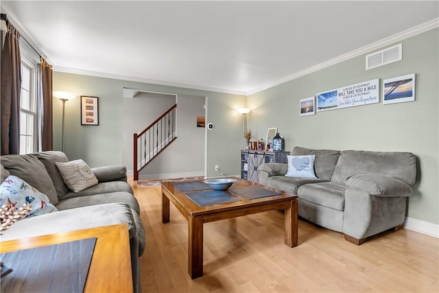 104 Textor Dr N, Versailles, PA 15137 - living area featuring light wood-style floors, crown molding, and stairway