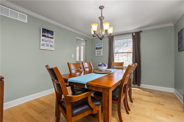 104 Textor Dr N, Versailles, PA 15137 - dining room with light wood-type flooring, a chandelier, and ornamental molding